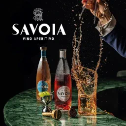 Savoia Vino Aperitivo bottles on a green marble bar beside a glass splashing as a hand drops ice into it.